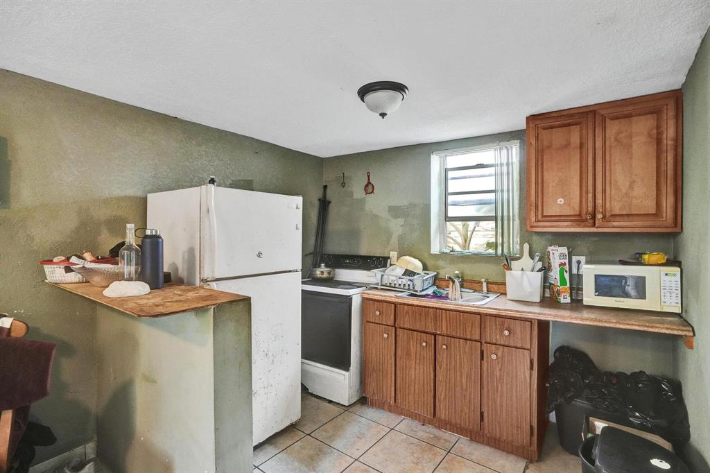Allapattah Miami, FL 33142 - Photo 50 of 58 a kitchen with a sink a stove and cabinets