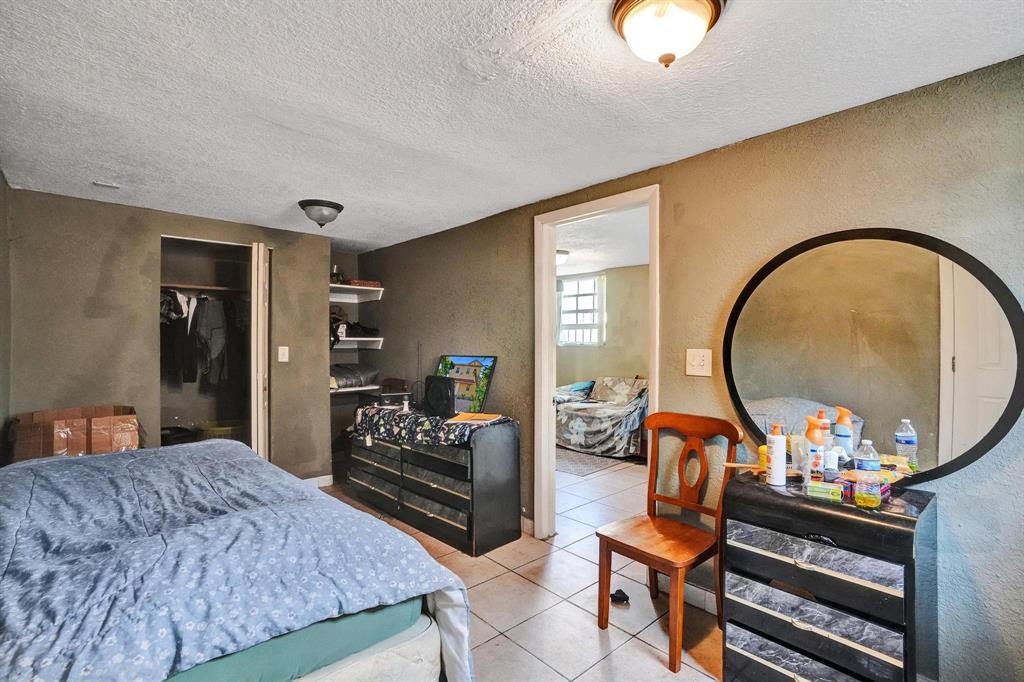 Allapattah Miami, FL 33142 - Photo 52 of 58 a living room with furniture a rug and a chandelier