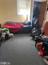 a bedroom with a bed and a mirror