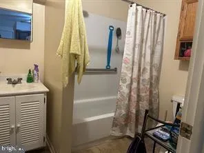 a bathroom with a bathtub a sink and a shower