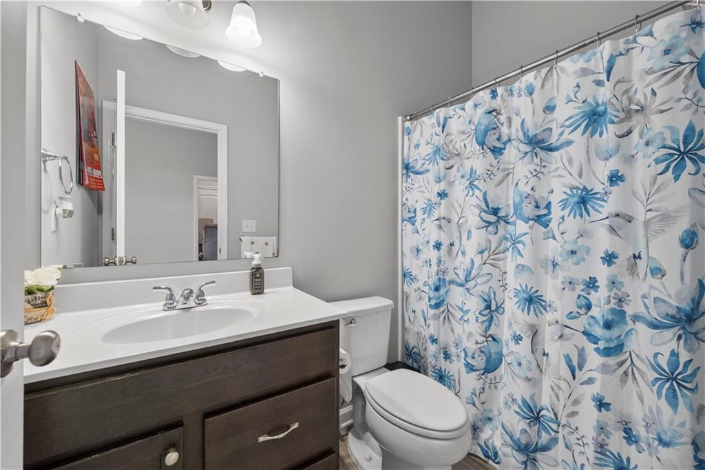 4607 Underwood Walk Powder Springs, GA 30127 - Photo 26 of 31 a bathroom with a sink toilet and mirror