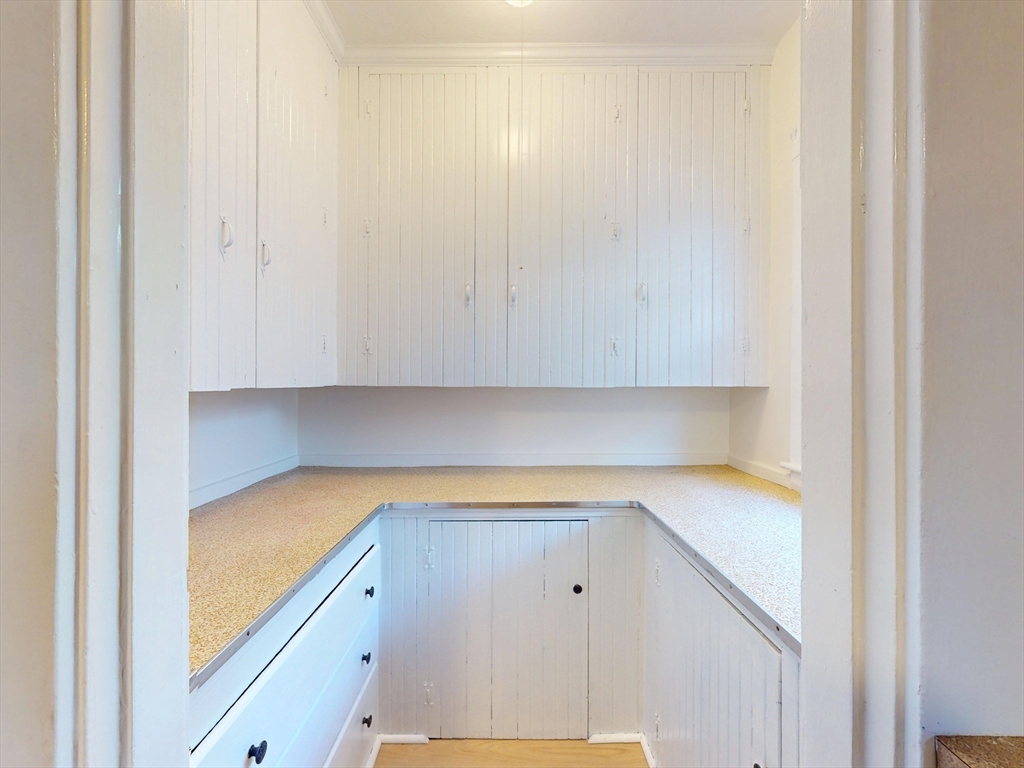 12 Park Street, Unit 2 Waltham, MA 02453 - Photo 12 of 20 a view of cabinets and wooden floor