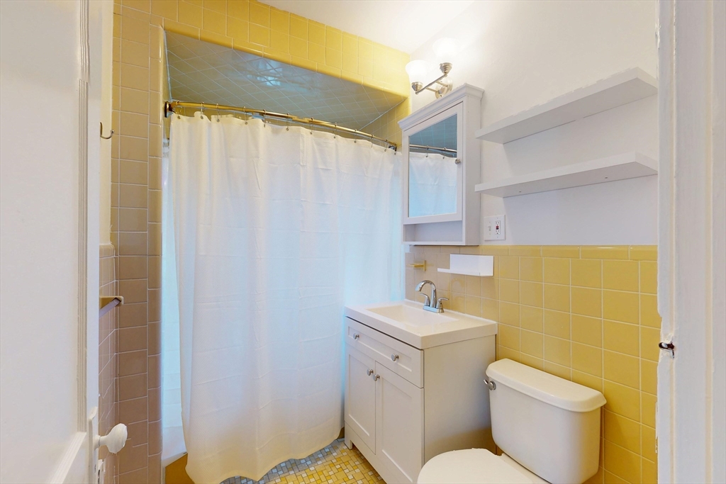 12 Park Street, Unit 2 Waltham, MA 02453 - Photo 16 of 20 a bathroom with a toilet sink and shower