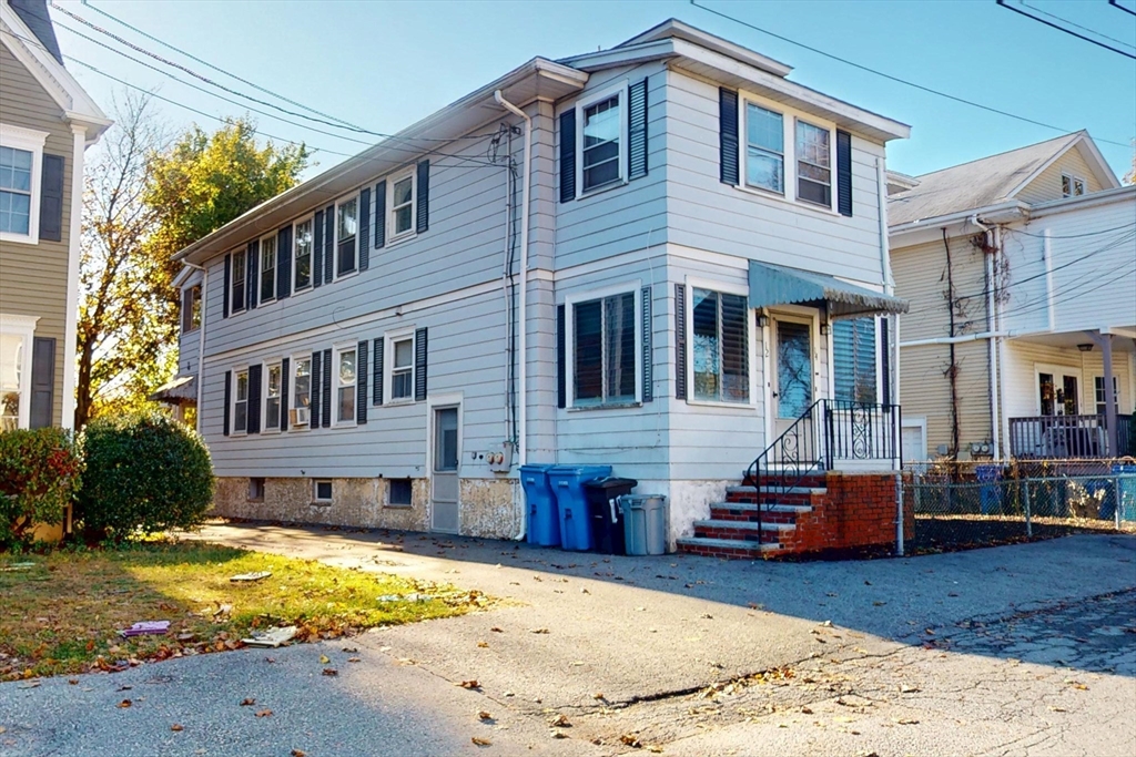 12 Park Street, Unit 2 Waltham, MA 02453 - Photo 20 of 20 a front view of a house with a yard covered with snow