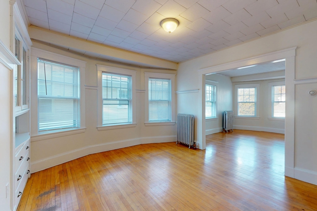 12 Park Street, Unit 2 Waltham, MA 02453 - Photo 7 of 20 a view of empty room with wooden floor and fan