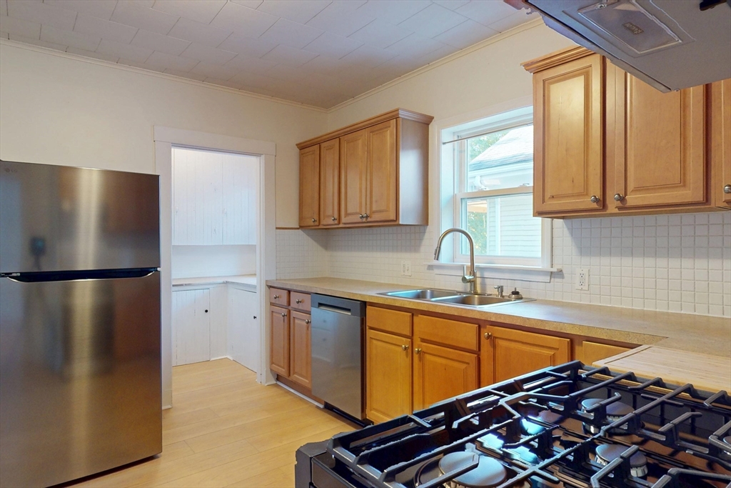 12 Park Street, Unit 2 Waltham, MA 02453 - Photo 10 of 20 a kitchen with stainless steel appliances a refrigerator and a sink