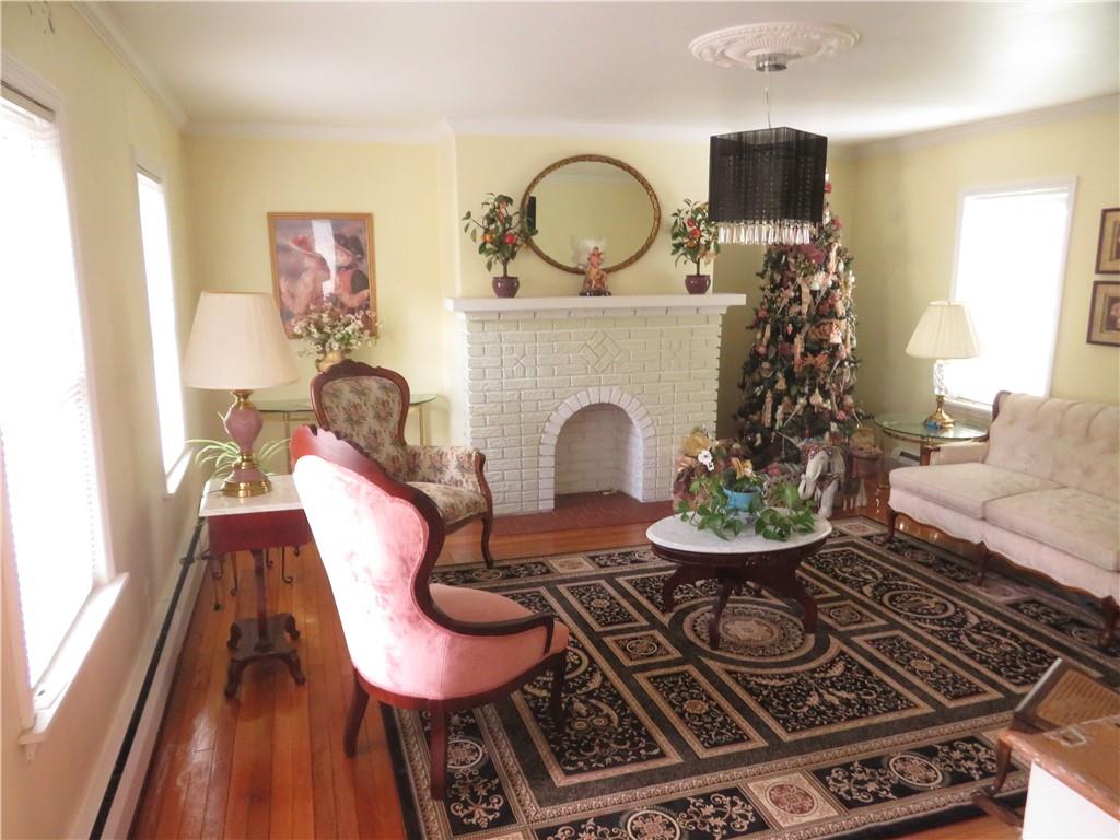 629 Freeport Road Butler, PA 16002 - Photo 8 of 26 a living room with furniture a rug and a fireplace