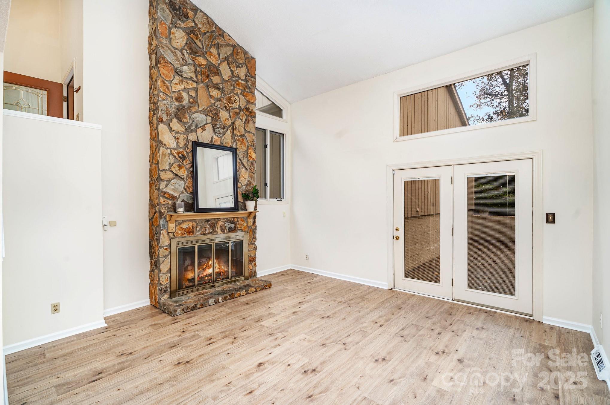 a view of a hallway with wooden floor and workspace