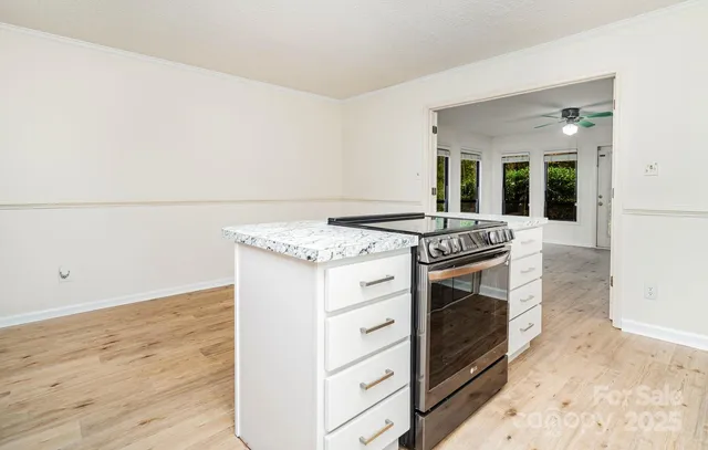 a kitchen with granite countertop a stove and a sink