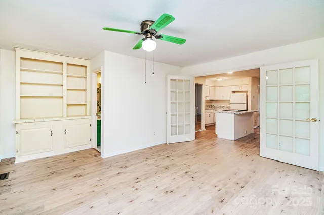 a view of a kitchen with a sink and a refrigerator