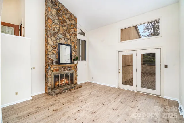a view of a hallway with wooden floor and workspace