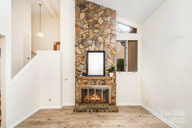 hallway with fireplace and wooden floor