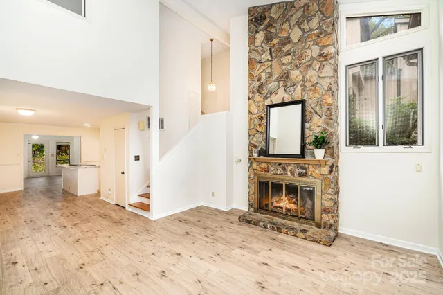 a view of a hallway with a living room filled with furniture