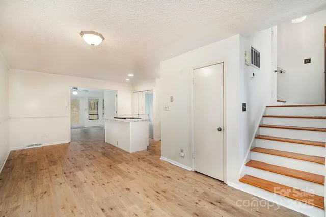 a view of a kitchen with a sink and refrigerator