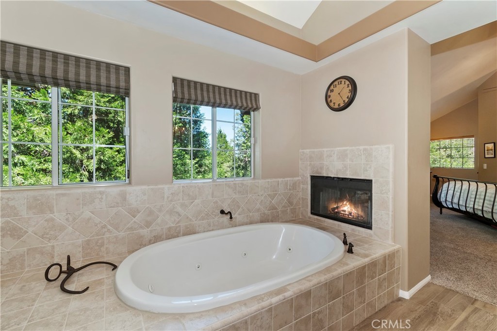 355 Cedar Ridge Drive Lake Arrowhead, CA 92352 - Photo 18 of 64 Gas fireplace shared with bath and bedroom.