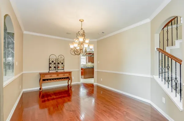 a view of a livingroom with wooden floor and stairs