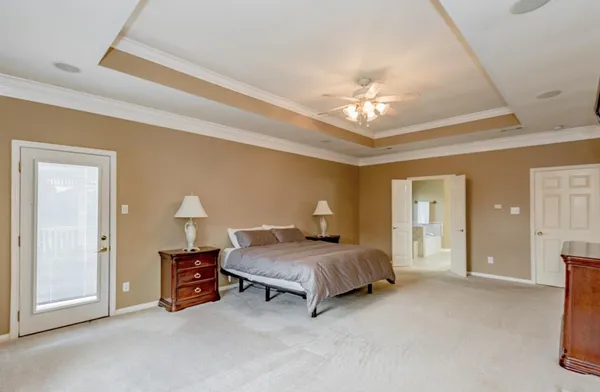 a bedroom with bed and a chandelier