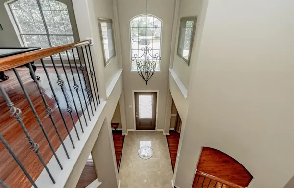 a view of entryway with wooden floor and stairs
