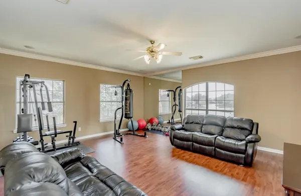 a living room with furniture ceiling fan and a window