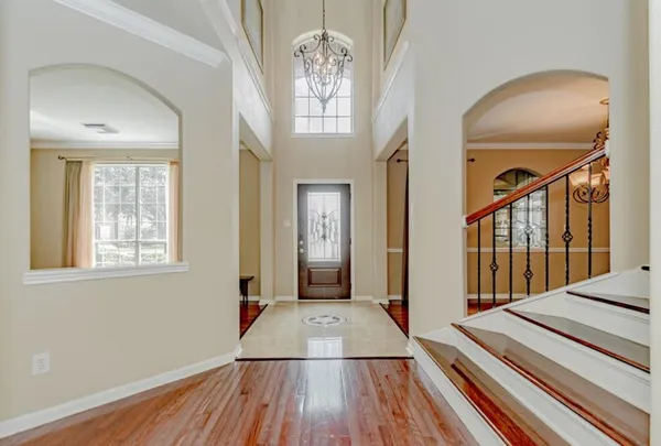 a view of a livingroom with wooden floor and a ceiling fan