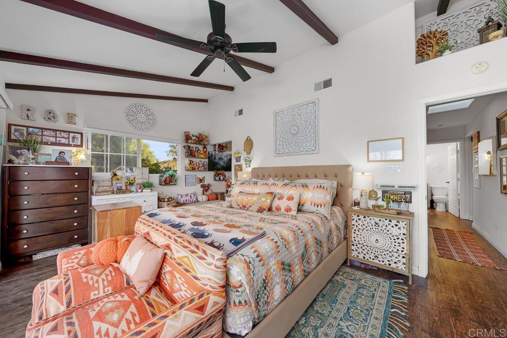 1356 South Grade Road Alpine, CA 91901 - Photo 15 of 68 a spacious bedroom with a bed a dresser and a chandelier