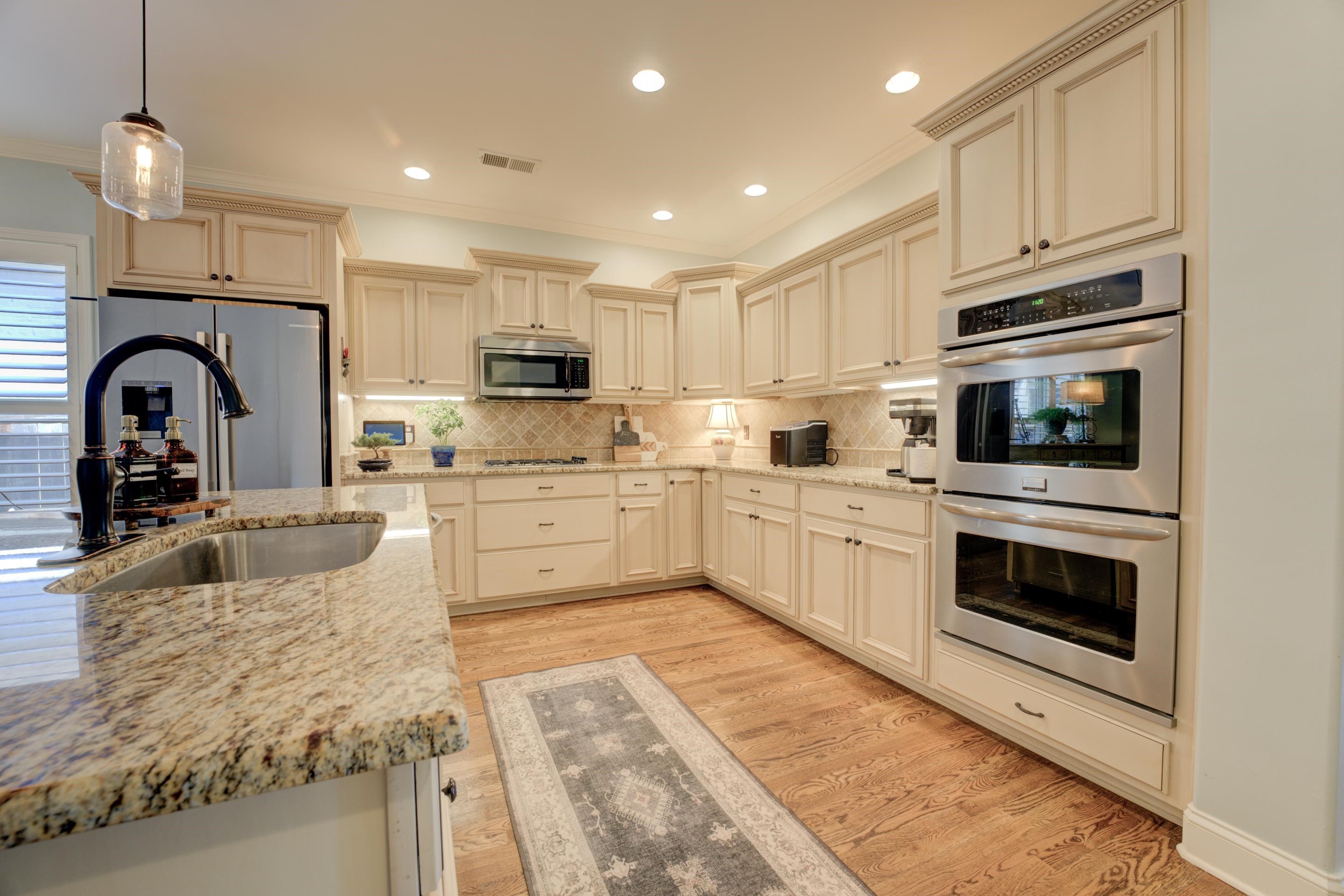389 West Tarren Mill Circle Collierville, TN 38017 - Photo 11 of 22 a kitchen with stainless steel appliances granite countertop a sink a stove top oven a counter space and cabinets