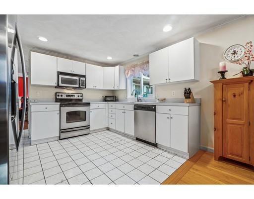 65 Grover Street Beverly, MA 01915 - Photo 11 of 33 a kitchen with a sink a window and stainless steel appliances