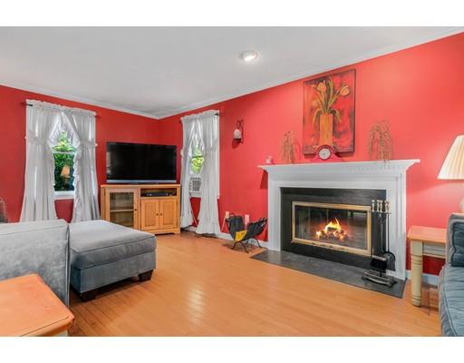 65 Grover Street Beverly, MA 01915 - Photo 14 of 33 a living room with furniture a fireplace and a flat screen tv