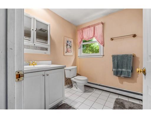 65 Grover Street Beverly, MA 01915 - Photo 27 of 33 a bathroom with a toilet a sink a window and mirror