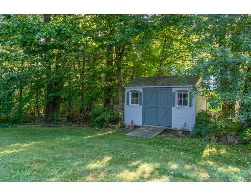65 Grover Street Beverly, MA 01915 - Photo 31 of 33 a view of a backyard with potted plants and large trees