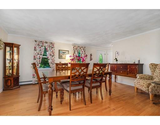 65 Grover Street Beverly, MA 01915 - Photo 7 of 33 a view of a dining room and livingroom with furniture a rug a painting and a chandelier