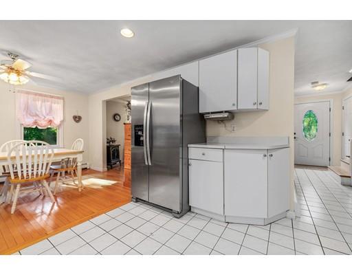 65 Grover Street Beverly, MA 01915 - Photo 9 of 33 a kitchen with stainless steel appliances kitchen island granite countertop a refrigerator and a stove