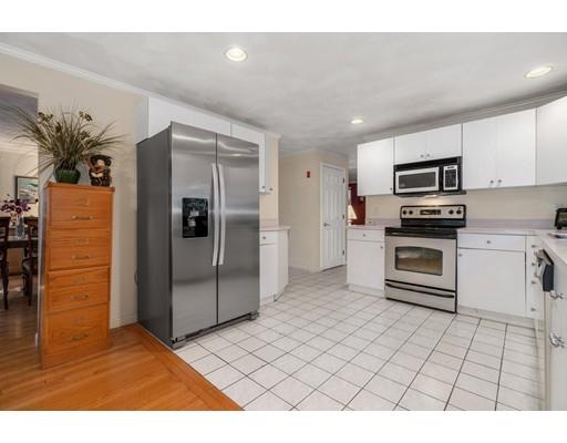 65 Grover Street Beverly, MA 01915 - Photo 10 of 33 a kitchen with stainless steel appliances granite countertop a refrigerator and a stove