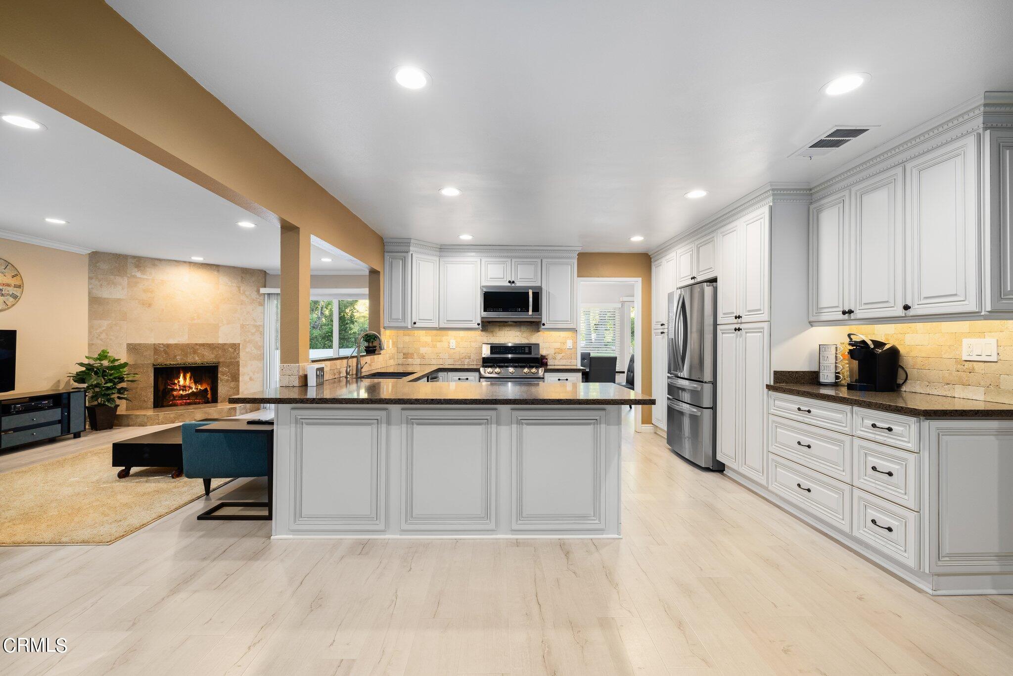 9356 Skyview Terrace Tujunga, CA 91042 - Photo 12 of 39 a kitchen with stainless steel appliances a stove a sink a refrigerator a center island and couches