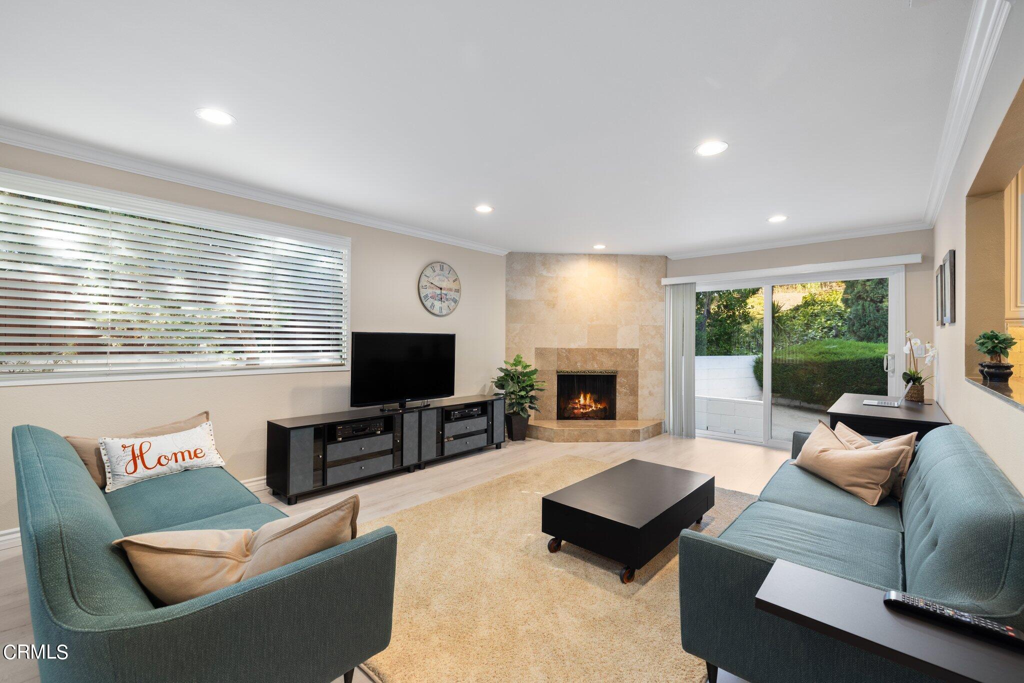 9356 Skyview Terrace Tujunga, CA 91042 - Photo 17 of 39 a living room with furniture flat screen tv and a large window