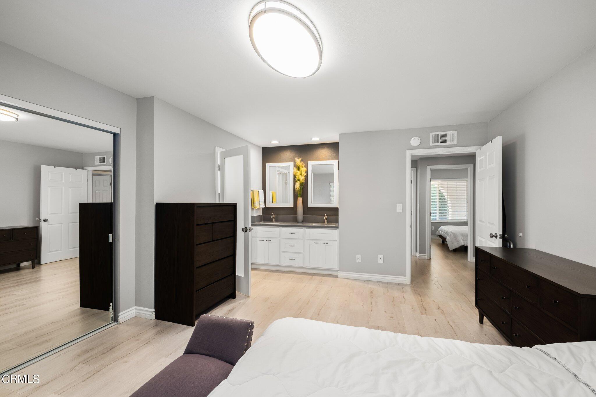 9356 Skyview Terrace Tujunga, CA 91042 - Photo 21 of 39 a living room with couches and closet with wooden floor