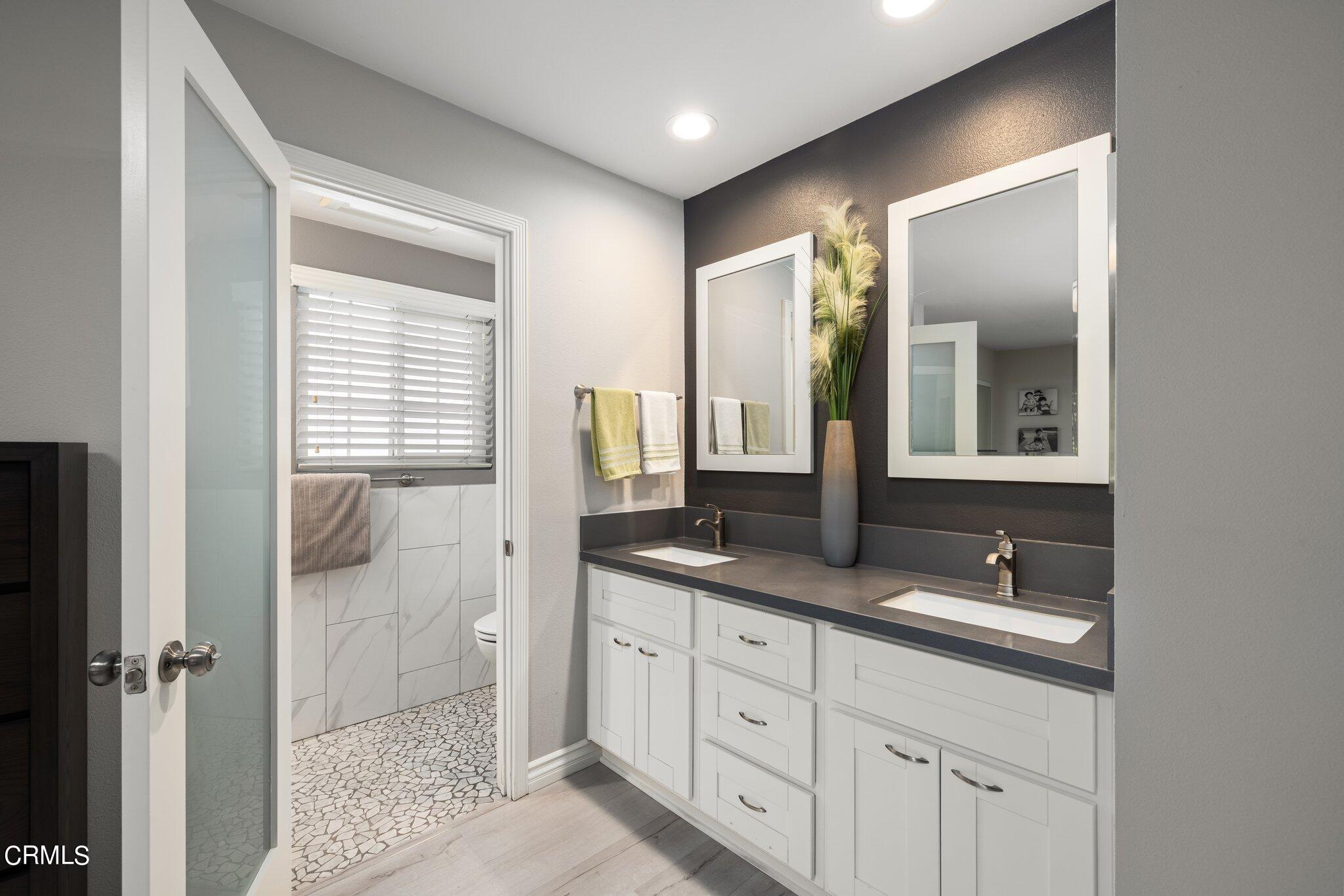 9356 Skyview Terrace Tujunga, CA 91042 - Photo 23 of 39 a bathroom with double sink and two mirror