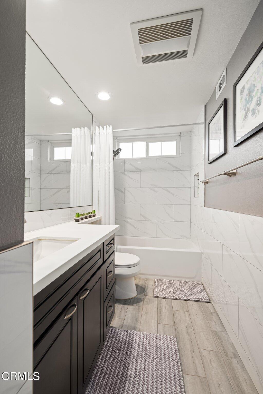 9356 Skyview Terrace Tujunga, CA 91042 - Photo 28 of 39 a bathroom with a sink a toilet a mirror and shower