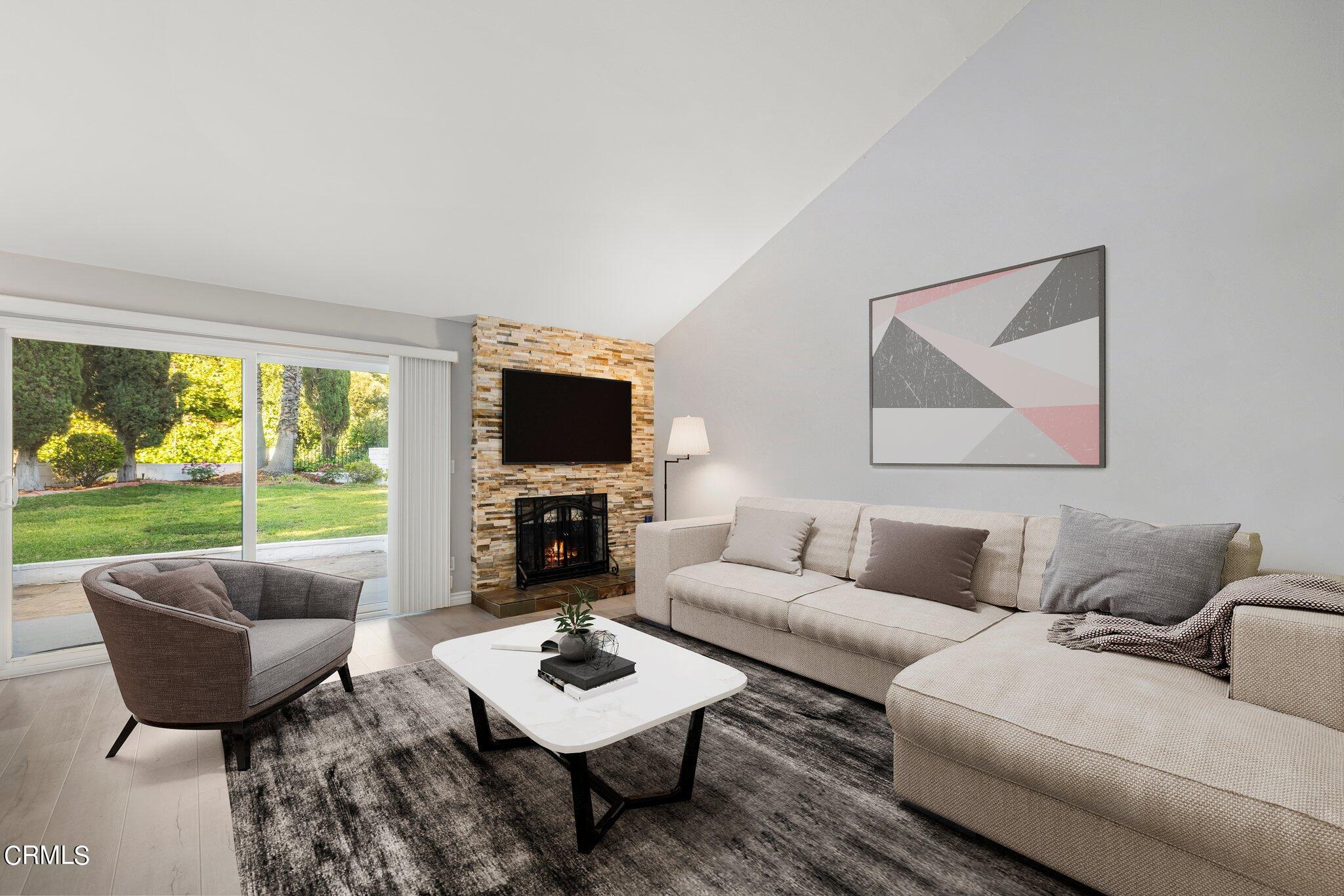 9356 Skyview Terrace Tujunga, CA 91042 - Photo 7 of 39 a living room with furniture a flat screen tv and a floor to ceiling window