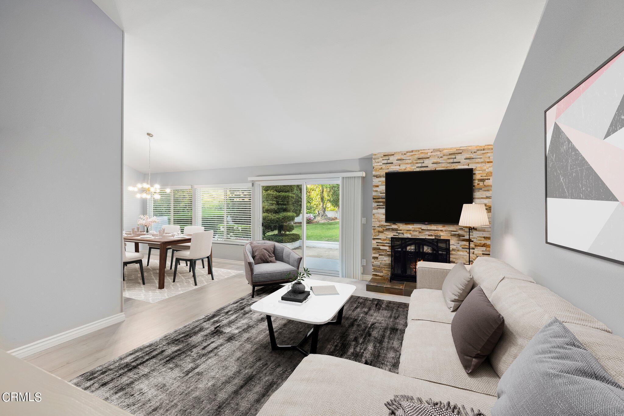 9356 Skyview Terrace Tujunga, CA 91042 - Photo 8 of 39 a living room with furniture a flat screen tv and a floor to ceiling window