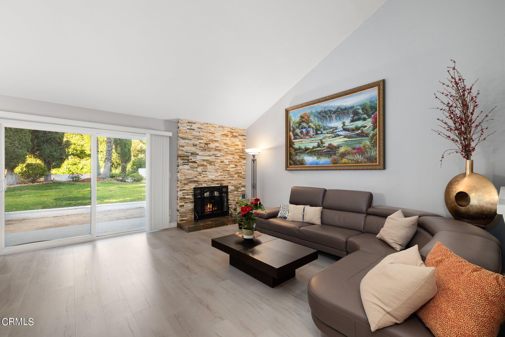 9356 Skyview Terrace Tujunga, CA 91042 - Photo 9 of 39 a living room with furniture fireplace and floor to ceiling windows
