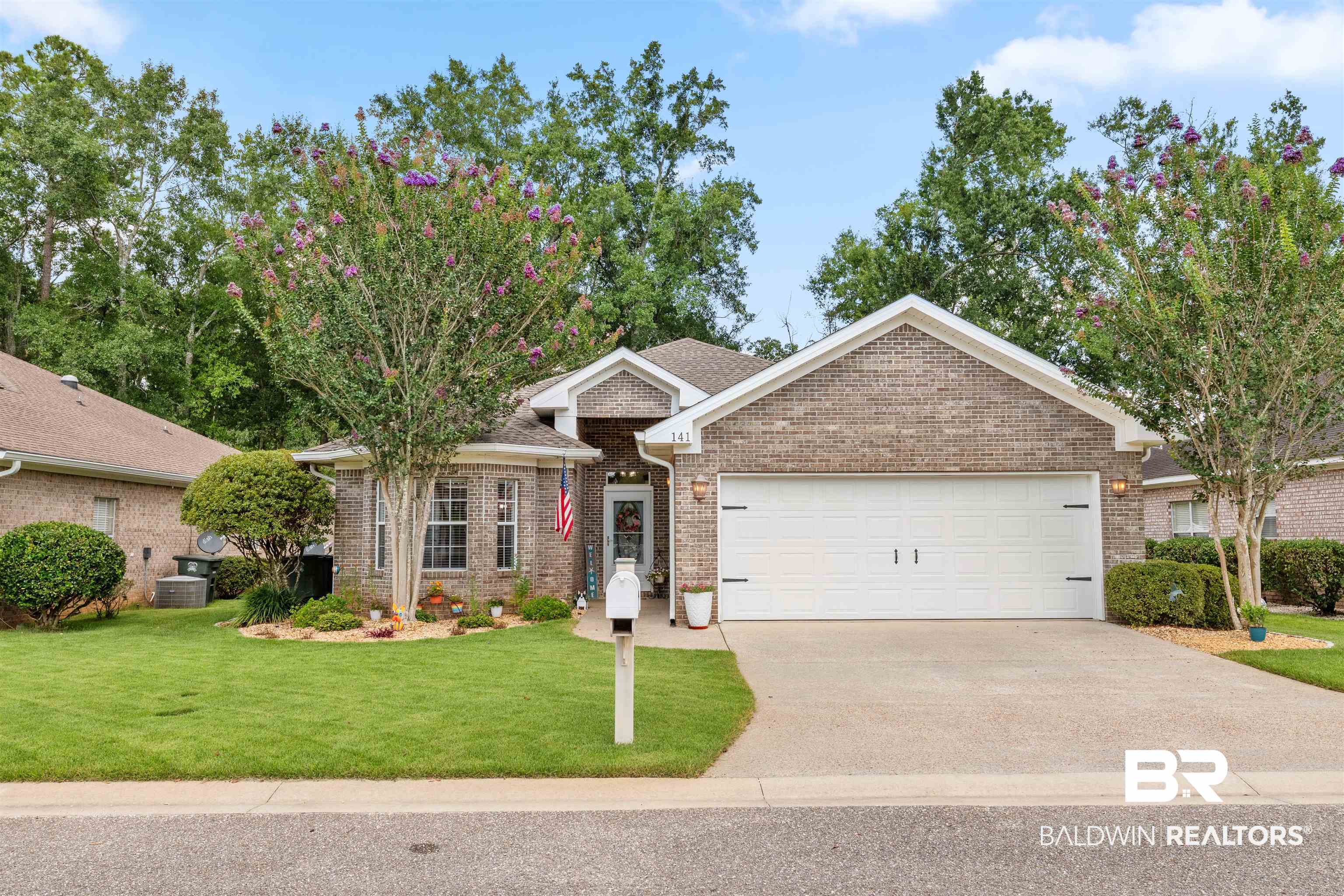 141 Mark Twain Loop Foley, AL 36535 - Photo 1 of 55 Single story home featuring driveway, brick siding, an attached garage, and a front yard