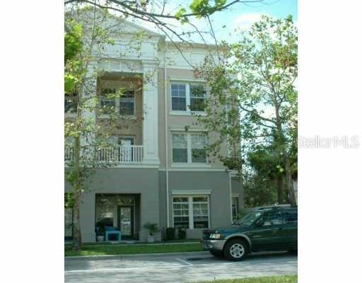 571 Water Street, Unit 571 Celebration, FL 34747 - Photo 1 of 26 a view of a car parked in front of a house