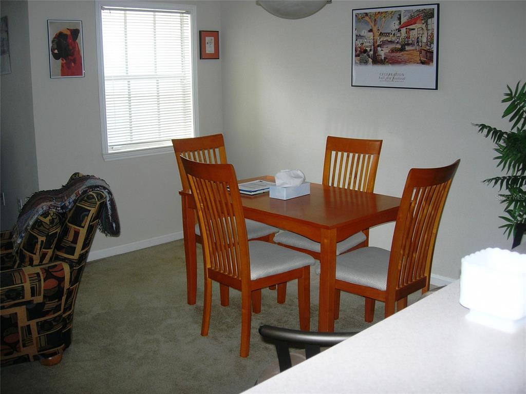 571 Water Street, Unit 571 Celebration, FL 34747 - Photo 13 of 26 a view of a dining room with furniture and window