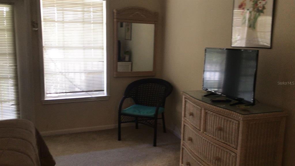 571 Water Street, Unit 571 Celebration, FL 34747 - Photo 15 of 26 a living room with furniture and a flat screen tv