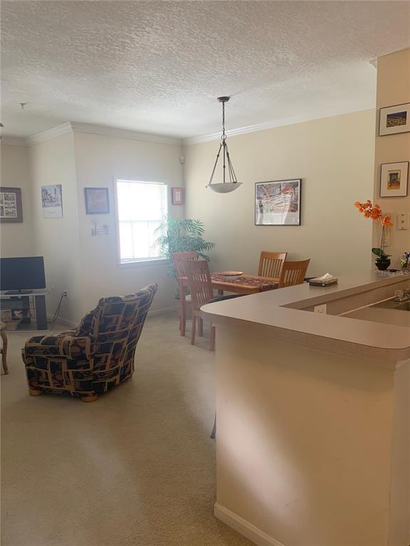 571 Water Street, Unit 571 Celebration, FL 34747 - Photo 17 of 26 a living room with furniture and a table