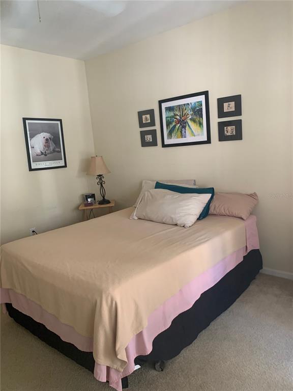 571 Water Street, Unit 571 Celebration, FL 34747 - Photo 18 of 26 a bedroom with a bed and painting on the wall