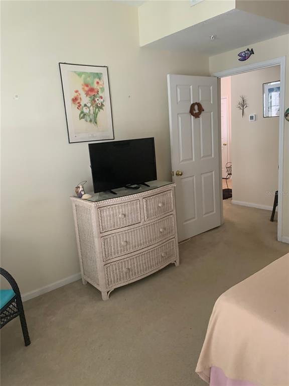 571 Water Street, Unit 571 Celebration, FL 34747 - Photo 19 of 26 a bedroom with furniture and flat screen tv