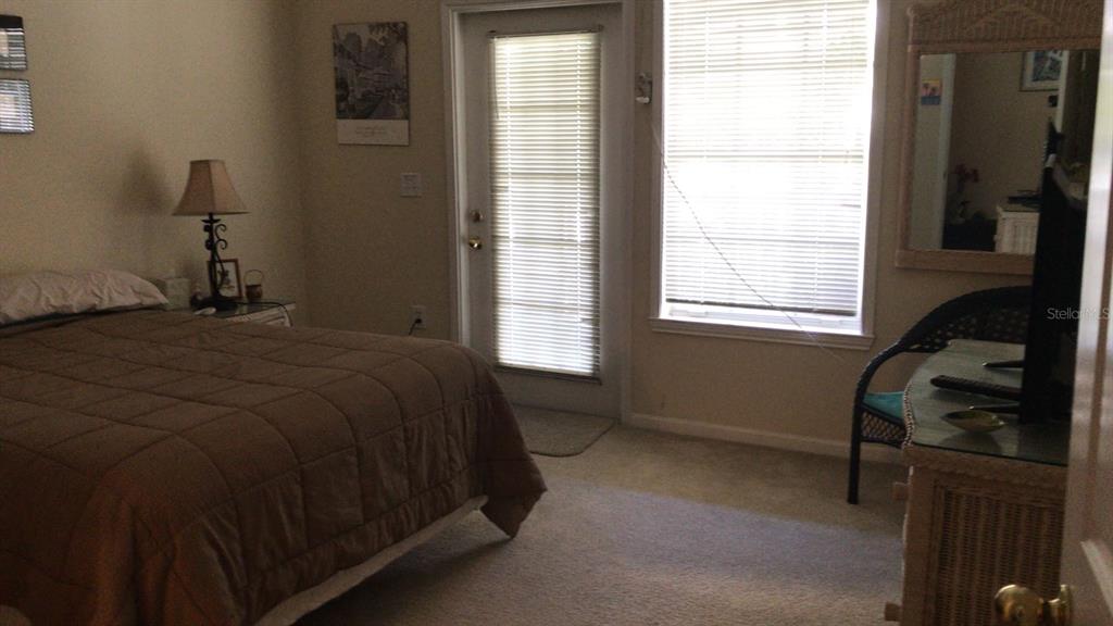 571 Water Street, Unit 571 Celebration, FL 34747 - Photo 21 of 26 a bedroom with a bed and a window