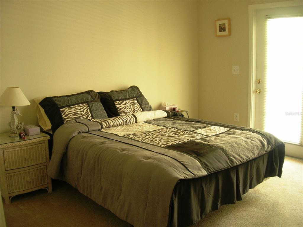 571 Water Street, Unit 571 Celebration, FL 34747 - Photo 5 of 26 a bedroom with a bed and a night stand